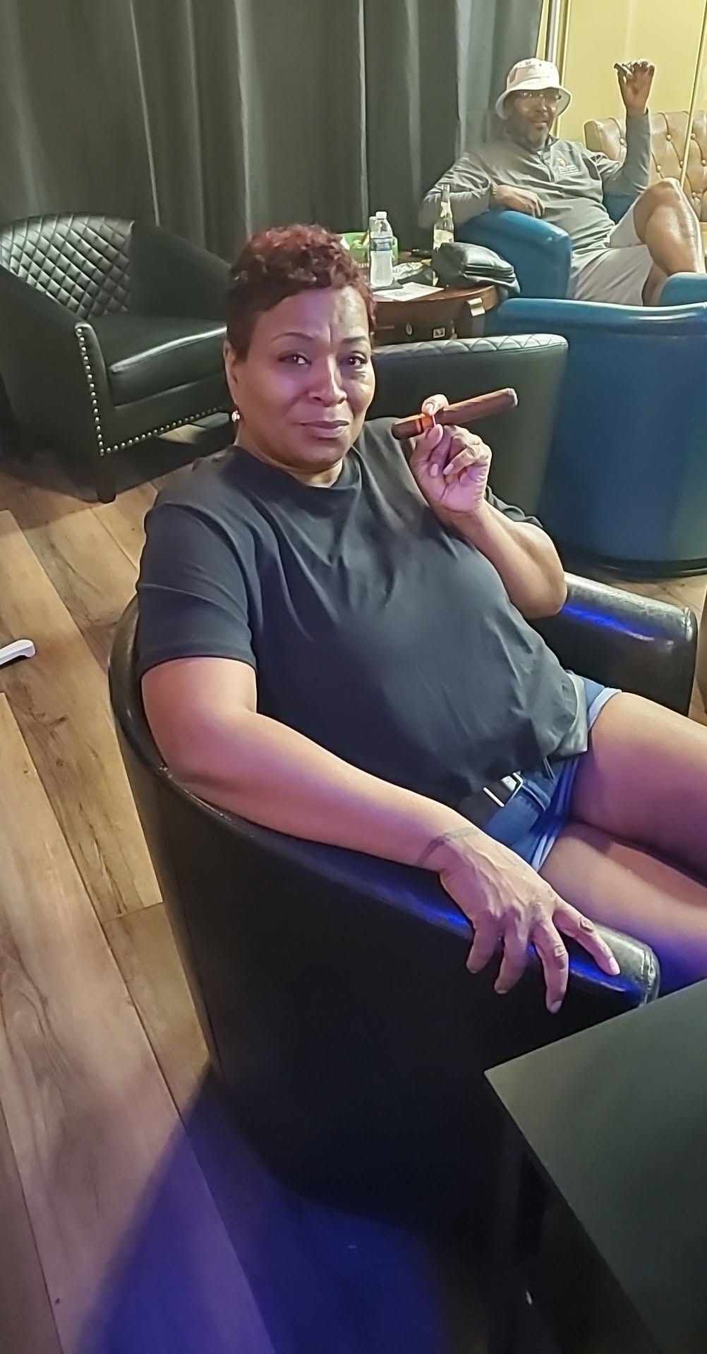 A guest relaxing with a cigar inside the lounge